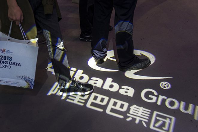 epa06769354 People walks on top of the Alibaba Group logo in front of their booth on Big Data expo in Guiyang, Guizhou Province, China, 28 May 2018. Big Data Industry Expo 2018 opened in Guiyang, which according to reports shall become the technical support center and Internet Content Provider (ICP) filing center for Alibaba Cloud, the cloud service of Chinese e-commerce giant Alibaba. All websites hosted on the Chinese mainland must be ICP filed with the Ministry of Industry and Information Technology. A website cannot direct to any server located on the Chinese mainland for public visits until the developer get an ICP filing number. Alibaba Cloud will also provide cloud storage service for the research data of China's 500-metres-aperture Spherical Radio Telescope in Guizhou Province, the world's largest single-dish radio telescope.  EPA/Aleksandar Plavevski